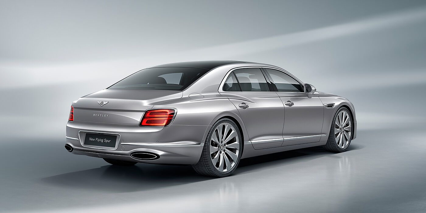 Bentley Muscat New Bentley Flying Spur sedan rear view in Silverlake paint with ten spoke wheels and chrome matrix grille