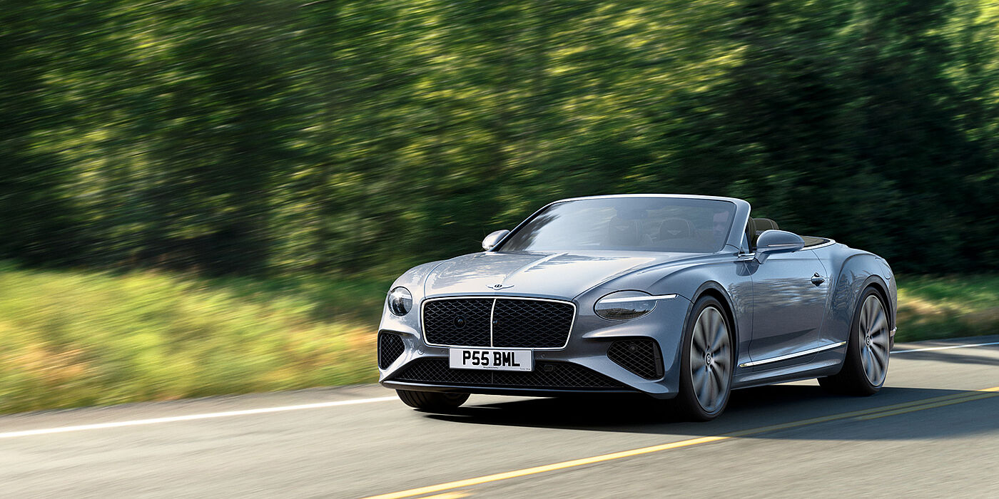 Bentley Muscat New Bentley Continental GTC convertible front view in Silverlake paint with 22 inch ten spoke wheels, driving dynamically on a country road
