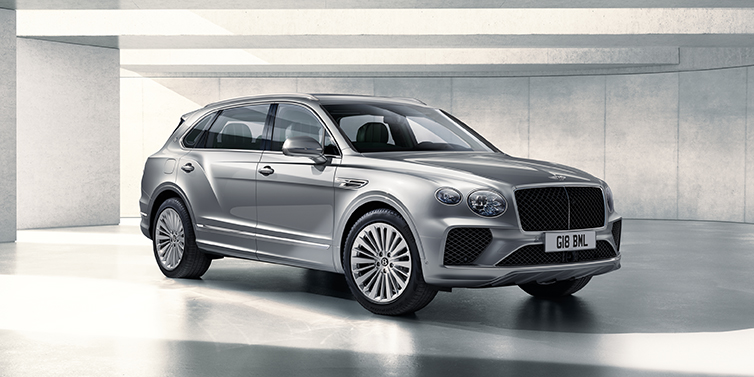 Bentley Muscat Bentley Bentayga Extended Wheelbase SUV front three quarter in Moonbeam paint with a grey background