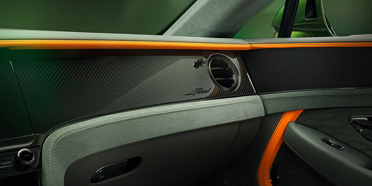 Bentley Muscat Bentley Continental GT Speed coupe front interior dash detail with high gloss carbon fibre veneer surrounded by Mandarin by Mulliner and Gravity Grey hides