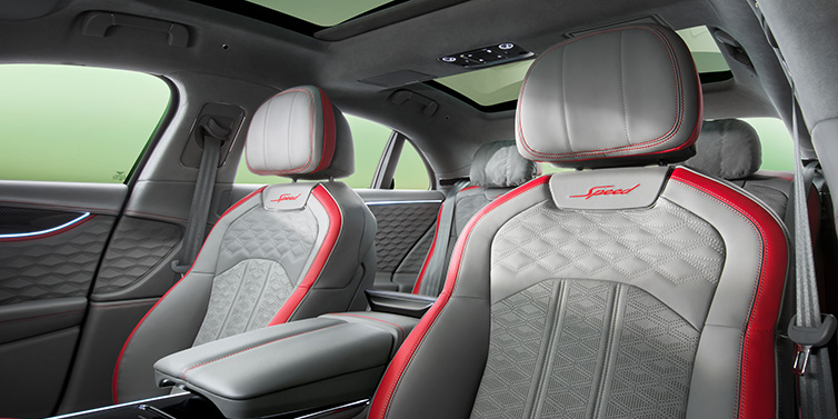 Bentley Muscat Bentley Flying Spur Speed sedan interior showing front and rear seats in Hotspur red and Gravity Grey hides, with Speed seat emblems