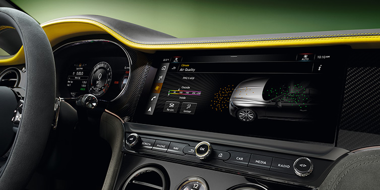 Bentley Muscat Bentley Continental GTC Speed convertible front interior centre console with MMI screen showing Air Quality visualisation surrounded by Cyber Yellow by Mulliner and Gravity Grey hides and high gloss carbon fibre veneer